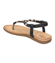 Sandalias de dedo planas para mujer SKYDIVA KELOKÉ en color negro, vista lateral talón